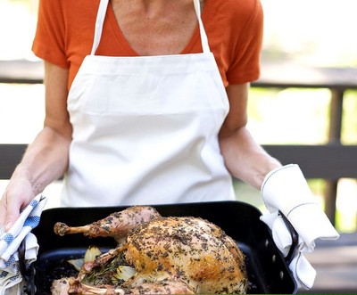 Person holding a turkey dinner plate